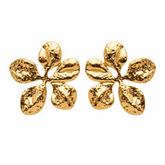 A pair of textured gold flower-shaped stud earrings on a plain white background.