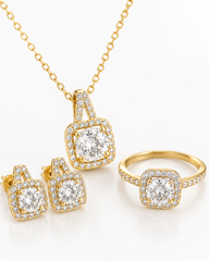 Gold jewelry set featuring a necklace, ring, and earrings with matching square halo designs set with clear gemstones, displayed on a clean white background.