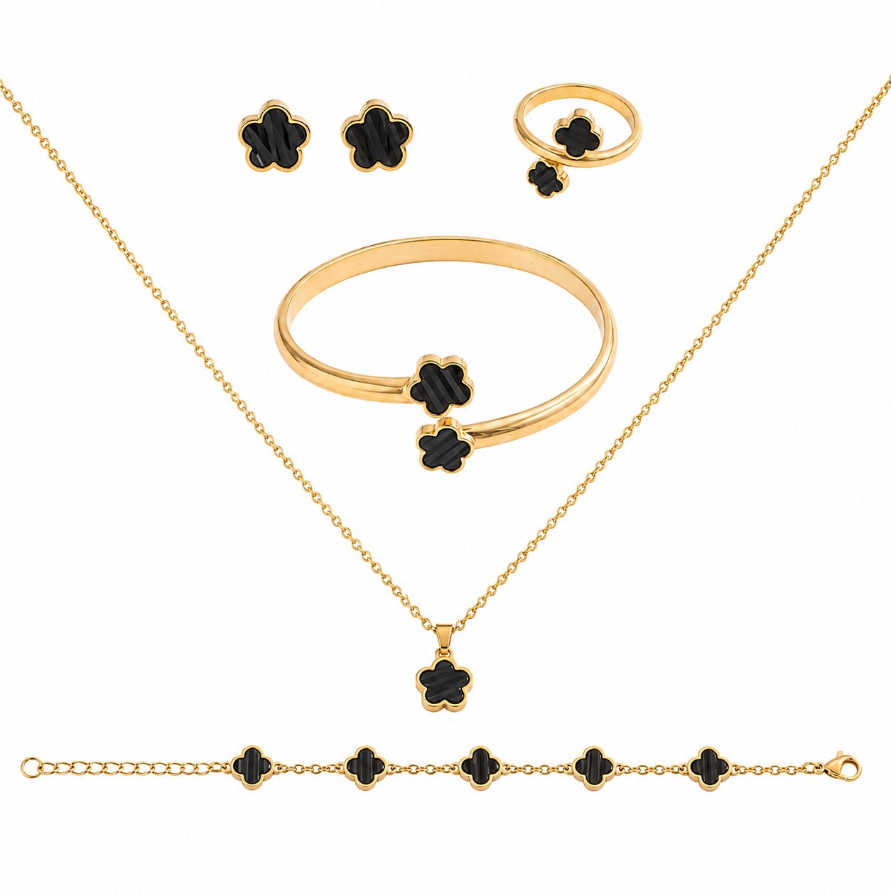 Gold jewelry set with black enamel clover motifs, including a necklace, bracelet, ring, and earrings, arranged on a white background.