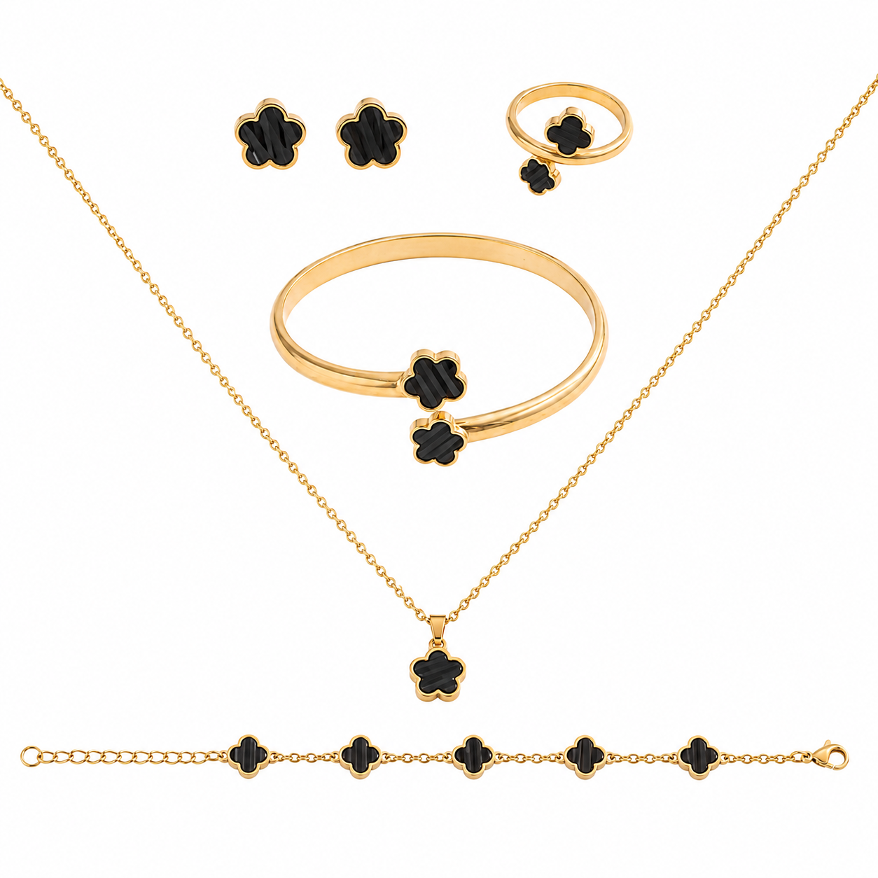 Gold jewelry set with black enamel clover motifs, including a necklace, bracelet, ring, and earrings, arranged on a white background.