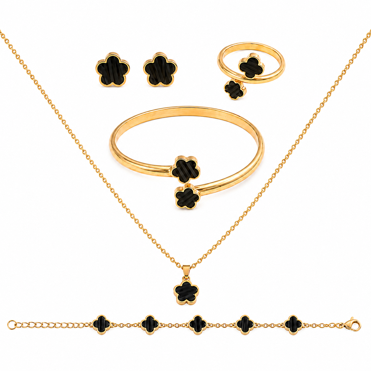 Gold jewelry set with black clover-shaped accents, including a necklace, bracelet, ring, and earrings, arranged on a white background.