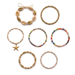 Seven beaded bracelets arranged on a plain white background, including shell-style, gold bead, rainbow bead, starfish charm, and pastel bead designs.