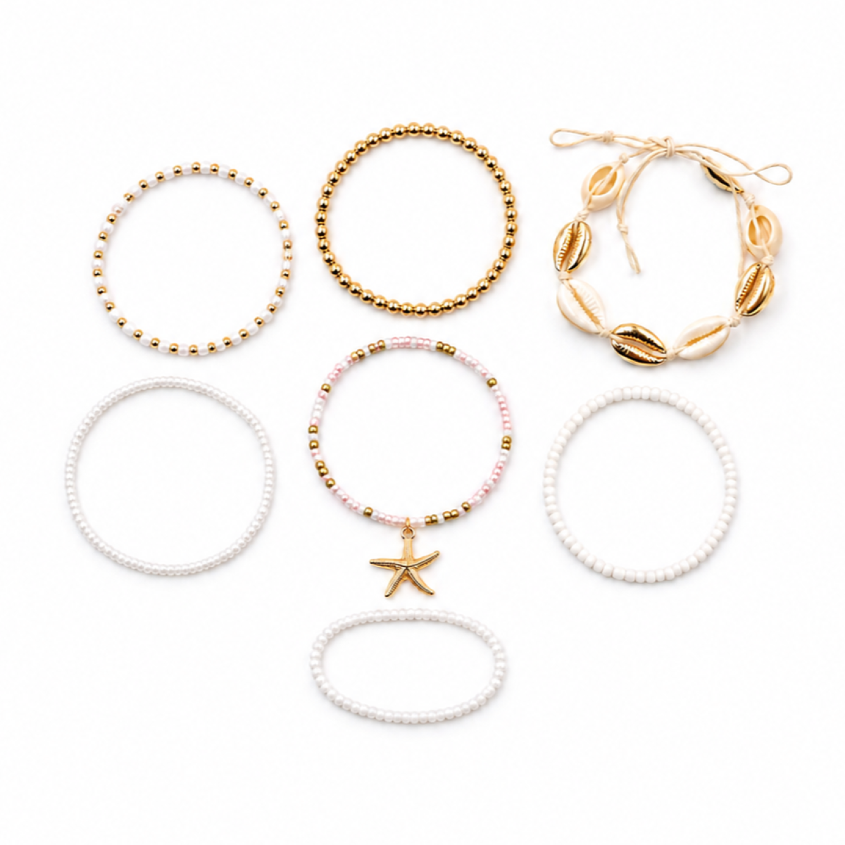 Six elastic beaded bracelets arranged on a plain white background, including gold bead rings, a white pearl bracelet with a gold starfish charm, a pink-and-gold beaded bracelet, and a white shell-bead bracelet.