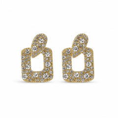 A pair of gold-tone statement earrings featuring a stylized open geometric shape paved with clear round and round-cut crystals, set against a plain white background.