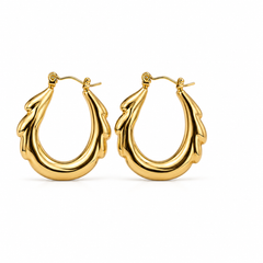 A pair of polished gold hoop earrings with a sculptural, organic wavy design, displayed on a clean white background.