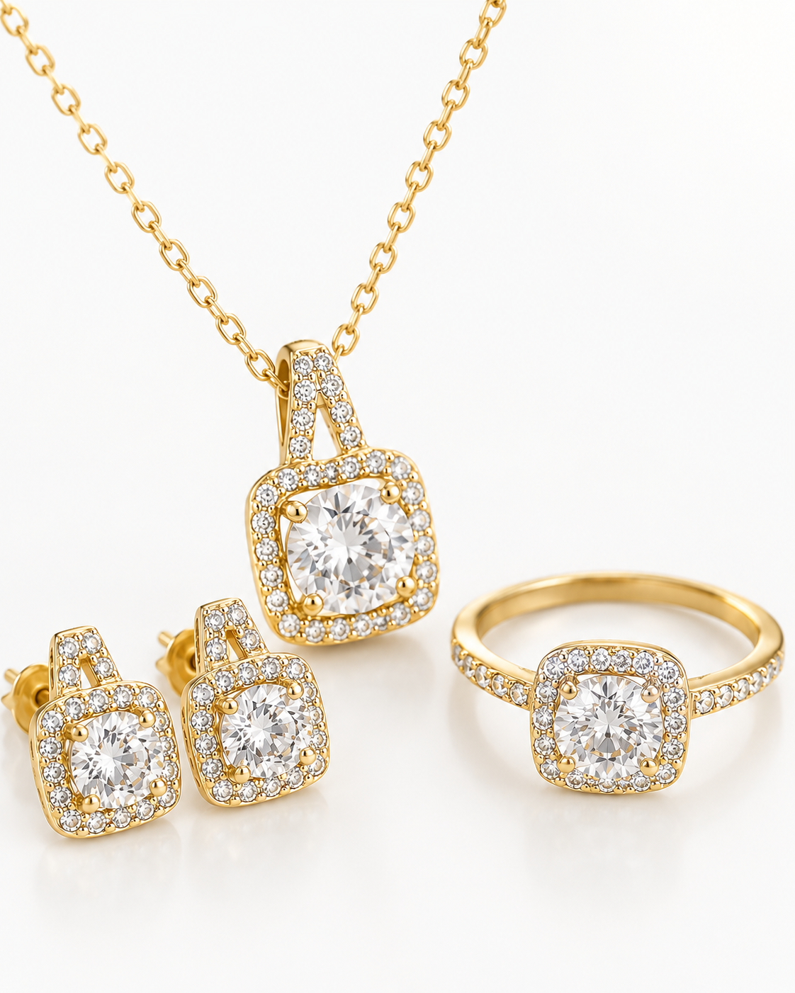 Gold jewelry set featuring a necklace, ring, and earrings with matching square halo designs set with clear gemstones, displayed on a clean white background.