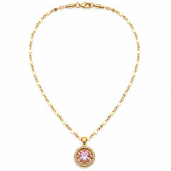A gold chain necklace with a round pendant featuring a pink gemstone surrounded by small clear stones, displayed on a clean white background.