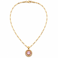 A gold chain necklace with a circular pendant featuring a pink gemstone surrounded by small clear stones, displayed on a clean white background.