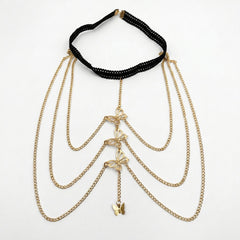 A gold-tone layered chain necklace with butterfly charms and a black beaded collar band, displayed on a clean white background.